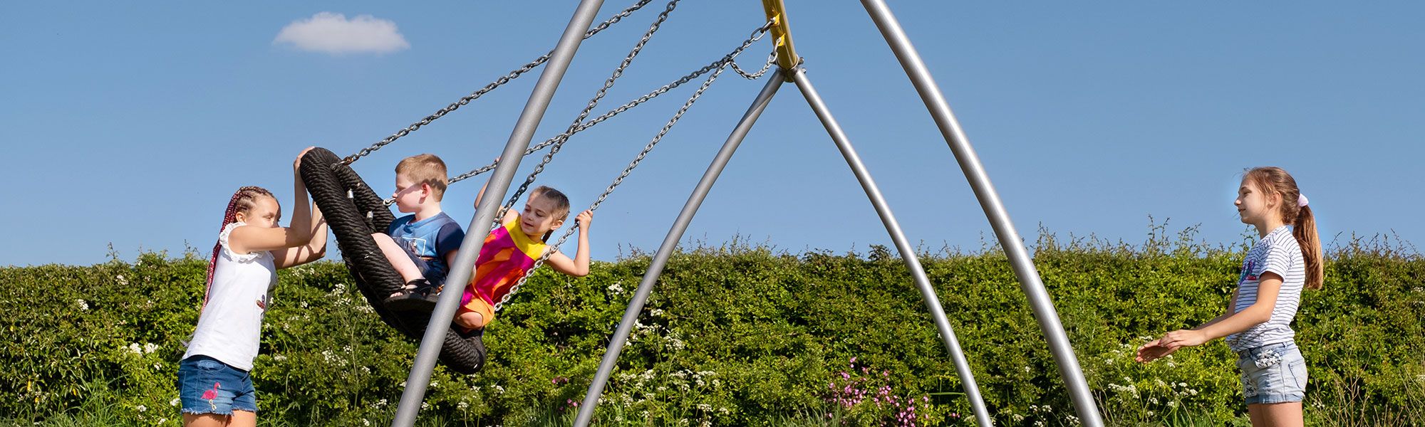 Children on outdoor swing