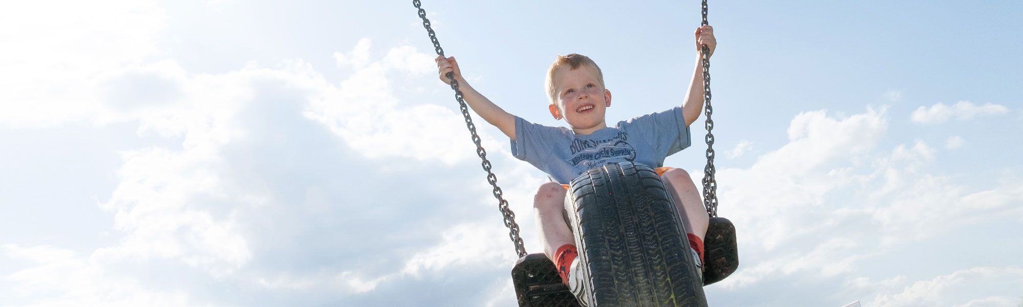 Child on tyre swing