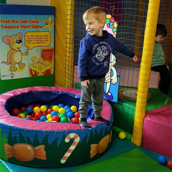 Child playing at indoor soft play area in North Wales