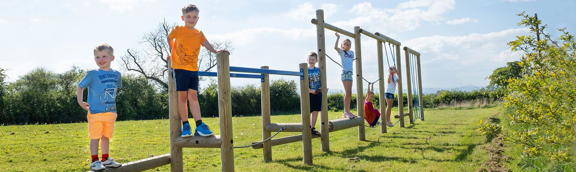 Children on climbing frame at outdoor park in North Wales